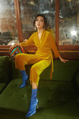 Wrap-style velvet blouse with structured waist and full-length sleeves for tailored elegance