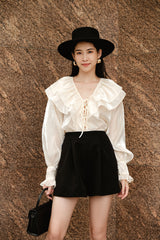 High-waisted silk skirt with pleated front and tailored silhouette for elegant styling