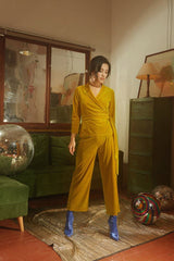 Wrap-style velvet blouse with structured waist and full-length sleeves for tailored elegance
