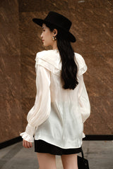 High-waisted silk skirt with pleated front and tailored silhouette for elegant styling