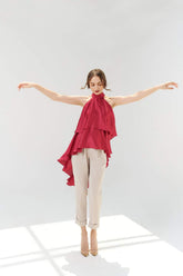 Silk halter top with tiered ruffle layers and asymmetric high-low draped hem