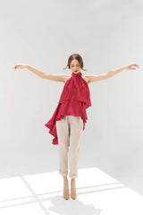 Silk halter top with tiered ruffle layers and asymmetric high-low draped hem