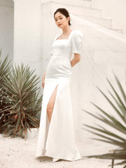 Silk dress with square neckline, puff sleeves, and front slit detail for modern elegance