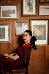 Elegant velvet midi dress with flutter sleeves and soft draped silhouette for timeless evening style