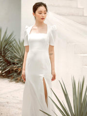 Silk dress with square neckline, puff sleeves, and front slit detail for modern elegance
