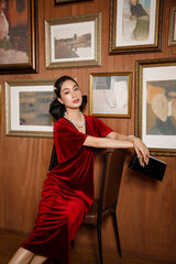 Elegant velvet midi dress with flutter sleeves and soft draped silhouette for timeless evening style