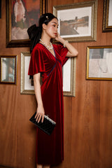 Elegant velvet midi dress with flutter sleeves and soft draped silhouette for timeless evening style