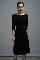 Velvet midi dress with boat neckline and pearl-trimmed sleeves for elegant occasions