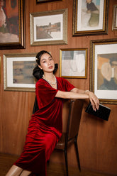 Velvet midi dress with draped front and flutter sleeves for refined evening elegance