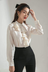 Silk blouse with cascading front ruffle and pearl collar button for timeless feminine elegance