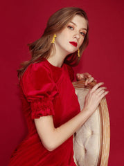 Velvet mini dress with puff sleeves and tailored silhouette for refined festive styling