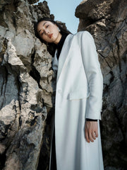 Tailored textured fabric long coat with peak lapels and buttoned cuffs for elegant layering