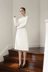 Long sleeve organza midi dress with twist-front detail and subtle cutout for elegant styling