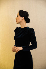 Velvet midi dress with ruched shoulder detail and sculpted silhouette for elegant evening wear