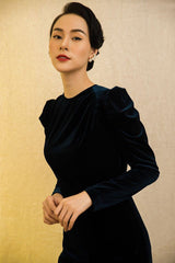 Velvet midi dress with ruched shoulder detail and sculpted silhouette for elegant evening wear
