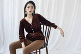 Velvet blouse with pearl button details and gathered waist for elegant shaping