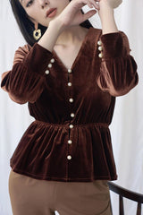 Velvet blouse with pearl button details and gathered waist for elegant shaping