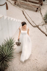 Sleeveless organza dress with soft tulle overlay and corset back detail for feminine elegance