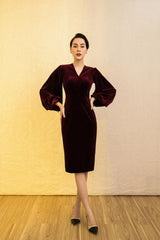 Velvet midi dress with deep V-neckline and dramatic bishop sleeves for elegant occasions