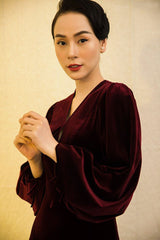 Velvet midi dress with deep V-neckline and dramatic bishop sleeves for elegant occasions