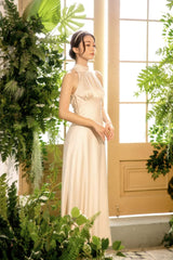 Elegant halter neck silk dress with open back and floor-length fluid silhouette