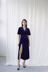 Velvet wrap midi dress with flutter sleeves and high slit for elegant evening styling