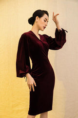 Velvet midi dress with deep V-neckline and dramatic bishop sleeves for elegant occasions