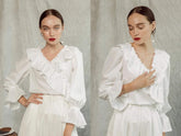 Silk blouse with ruffled V-neckline and flared cuffs for a romantic, feminine silhouette