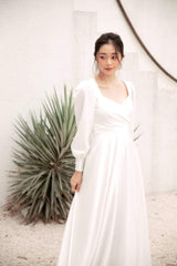 Long sleeve silk dress with open back and full-length A-line skirt for formal occasions