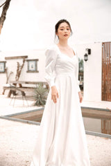 Long sleeve silk dress with open back and full-length A-line skirt for formal occasions