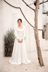 Long sleeve silk dress with open back and full-length A-line skirt for formal occasions