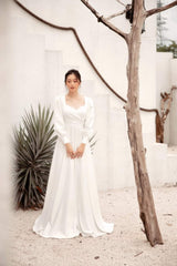 Long sleeve silk dress with open back and full-length A-line skirt for formal occasions