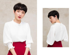 Silk blouse with smocked cuffs and ruffled neckline for a clean, softly structured finish