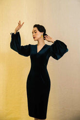 Velvet midi dress with voluminous long sleeves and structured V-neckline for evening wear
