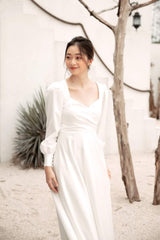 Long sleeve silk dress with open back and full-length A-line skirt for formal occasions