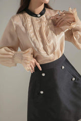 Silk A-line skirt with pearl button accents and tailored structure for modern feminine style