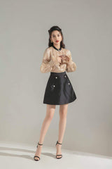 Silk A-line skirt with pearl button accents and tailored structure for modern feminine style