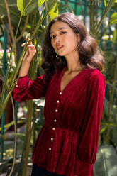 Soft velvet blouse with pearl button front and gathered waist for feminine definition