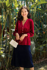 Pleated velvet midi skirt with soft flare and structured drape for elegant seasonal styling