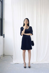 Fitted velvet midi dress with puff sleeves and scoop neckline for elegant evening style