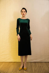 Velvet midi dress with long sleeves, boat neckline, and low back bow detail