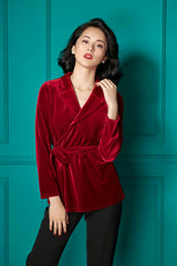 Tailored wrap-front velvet blouse with notched lapels and waist tie for evening elegance