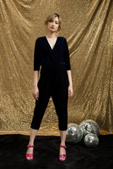 Soft velvet wrap blouse with 3/4 sleeves and gathered waist for a sleek feminine silhouette