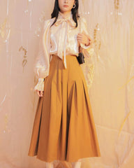 Silk midi skirt with structured pleats and high waist for a polished feminine silhouette