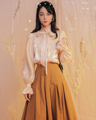 Silk midi skirt with structured pleats and high waist for a polished feminine silhouette