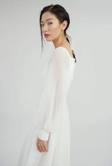 Elegant long-sleeve organza dress with square neckline and delicate textured bodice