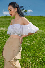 High-waisted midi linen skirt with front slit and utility pockets for refined everyday style