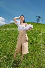 High-waisted midi linen skirt with front slit and utility pockets for refined everyday style