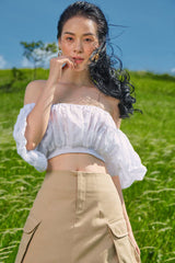 High-waisted midi linen skirt with front slit and utility pockets for refined everyday style