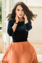 Pleated midi skirt in soft velvet fabric with flowy silhouette and structured waistband